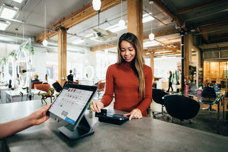 A small-business owner at the counter of their own shop, going over records